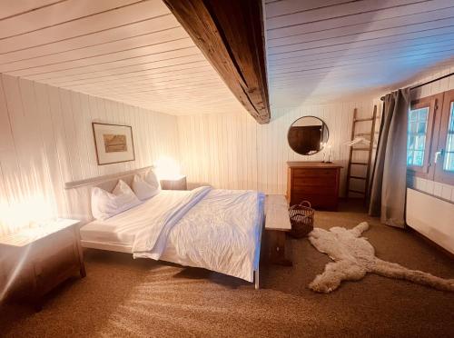 a bedroom with a bed and a teddy bear on the floor at Alpaka-Ferienhaus Oenzlen in Wynigen