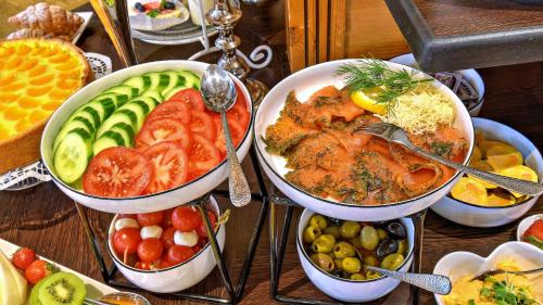 a table topped with bowls of different types of food at Boutique Hotel POST ANDECHS in Andechs