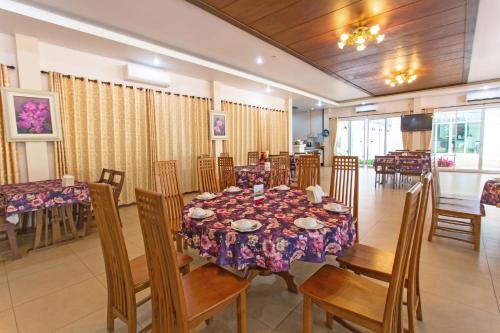 a dining room with a table and some chairs at Nantrungjai Boutique Hotel in Nan