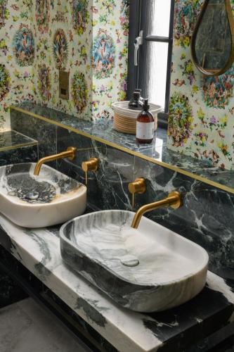 a bathroom with two sinks on a marble counter at The Tempus at Charlton Hall Estate in Alnwick