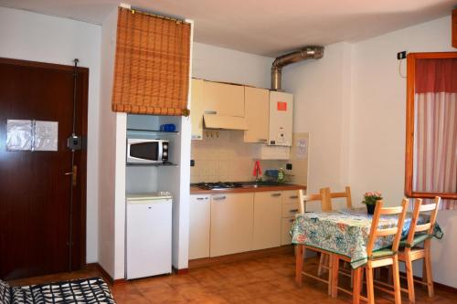 a small kitchen with a table and a refrigerator at Casa da Carlo in Pisa