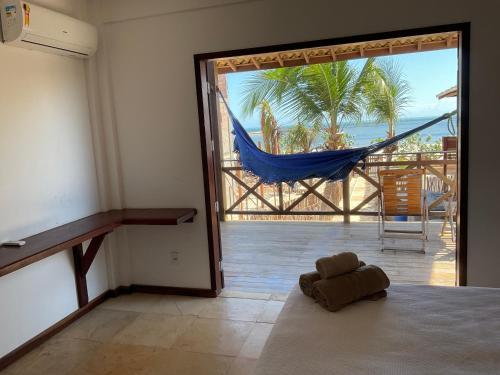 a room with a hammock and a view of a patio at BEACH HOUSE Barra Grande - CASA INTEIRA - WHOLE HOUSE in Barra Grande
