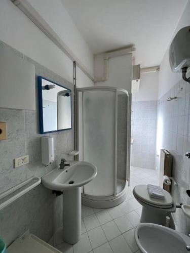 a bathroom with a shower and a sink and a toilet at Cav 1 Holiday beach in San Vincenzo