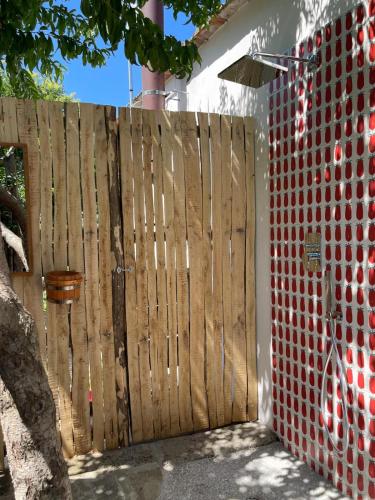 a wooden fence next to a red brick wall at Casa Lucia in Sorrento