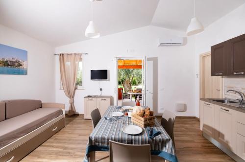 a kitchen and living room with a table and a couch at Agriturismo I Tesori del Sud Vieste, Puglia in Vieste