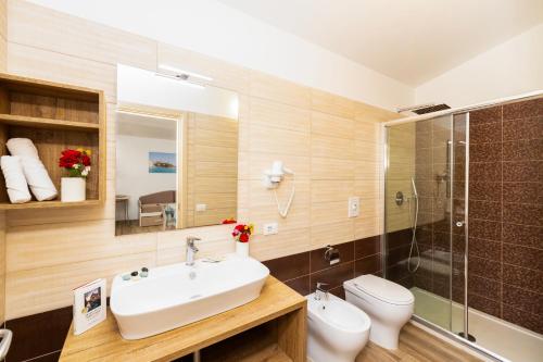 a bathroom with a sink and a toilet and a shower at Agriturismo I Tesori del Sud Vieste, Puglia in Vieste