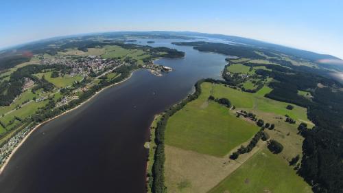 an aerial view of a river and a city at Penzion Panter in Horní Planá