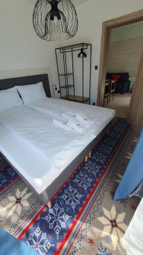 a large bed sitting on a rug in a room at Villa Olimpijska 2 - Centrum in Wisła
