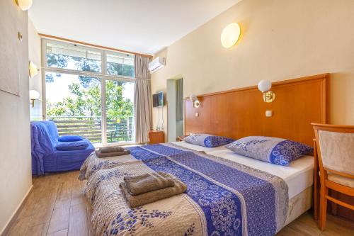 a hotel room with two beds and a window at Maestral Residence in Portorož