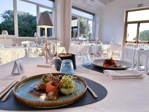 a table with two plates of food on it at Villa MG Hotel in Santa Marinella