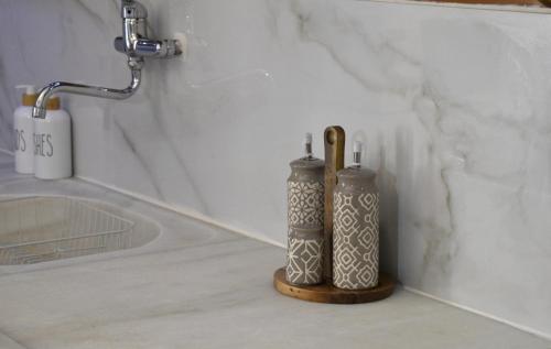 two vases sitting on a counter in a bathroom at To Spitaki Dalamanara in Dhalamanára