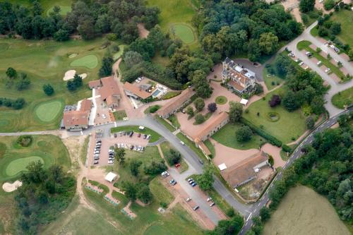 an aerial view of a house with a golf course at Château de Champlong Table Hôtel **** Golf & Spa in Villerest