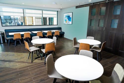 a waiting room with tables and chairs at Residence Inn by Marriott Rocklin Roseville in Roseville
