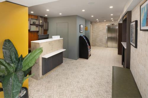 an office lobby with a surfboard on the wall at Four Points by Sheraton Edinburgh in Edinburgh