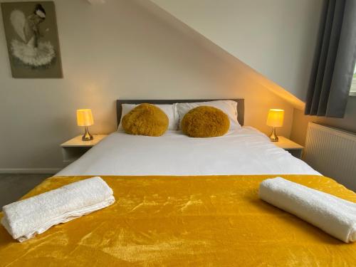 a bedroom with a bed with two towels on it at Cosy room Maidstone in Kent