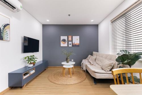a living room with a couch and a table at LAGOM APARTMENT AND HOTEL in Da Nang