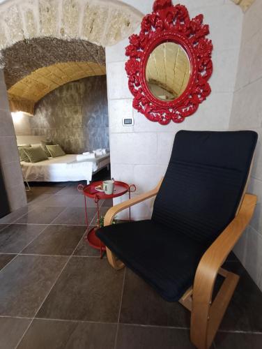 a room with a chair and a mirror at L'otto in Mesagne