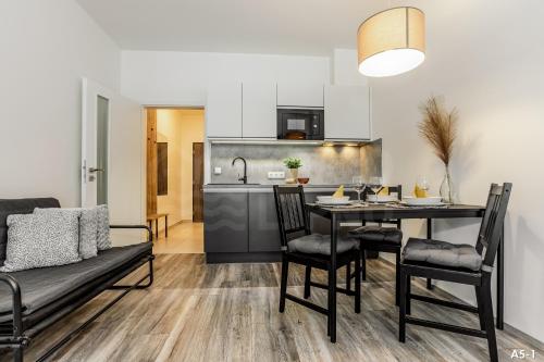 a kitchen and dining room with a table and chairs at KORZO LIPNO 2 in Lipno nad Vltavou