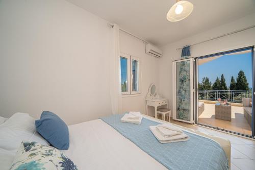 sypialnia z łóżkiem i balkonem z widokiem na okolicę w obiekcie Villa Elaionas 2 in Svoronata! w mieście Svoronata