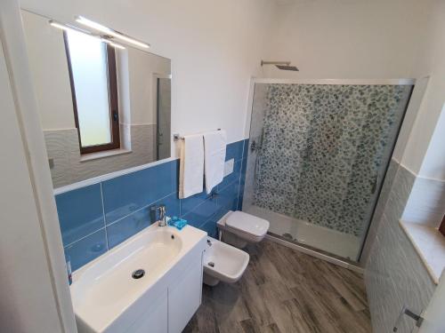 a bathroom with a sink and a glass shower at La dolce vita in Agerola