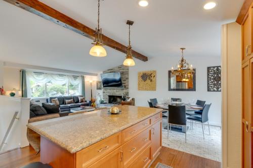 a kitchen and living room with a couch and a table at Kenmore Retreat with Shared Hot Tub - 1 Mi to Lake! in Kenmore