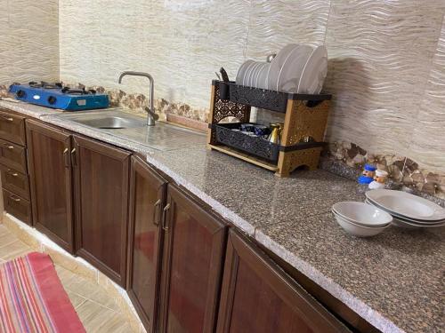 a kitchen with a counter top with a sink at Pink city cottage in Wadi Musa