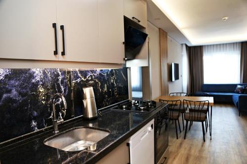 a kitchen with a sink and a counter top at Kemer Sunrise Suit in Kemer