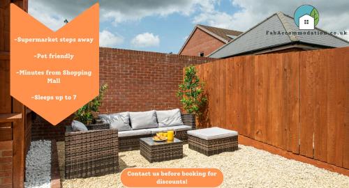 a patio with a fence and a couch in a backyard at Large 3Bed-Parking & Garden-By FabAccommodation in Bristol