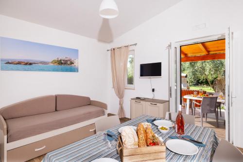 a living room with a couch and a table at Agriturismo I Tesori del Sud Vieste, Puglia in Vieste