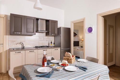 a kitchen with a table with plates on it at Agriturismo I Tesori del Sud Vieste, Puglia in Vieste