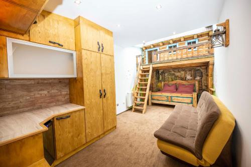 a room with a bunk bed and a chair in it at Hotel Kocourkov in Hlinsko