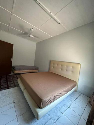 a bedroom with a large bed in a room at Warisan Homestay B in Mersing