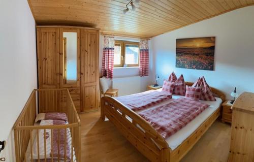 a bedroom with a large bed in a room at Essleggerhof in Fachau