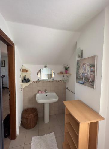 a bathroom with a sink and a mirror at Casa Solemar in Imperia