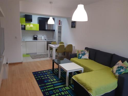 a living room with a couch and a kitchen at Moonlight Pent in Skopje