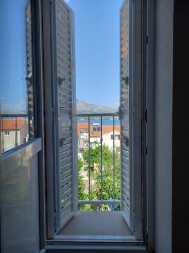 an open window with a view of a city at Apartments Filippi in Korčula