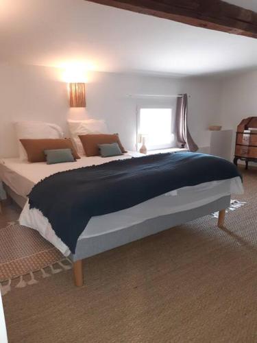 une chambre avec un grand lit dans une pièce dans l'établissement Maison de maître dans le village, bord de mer, à Torreilles