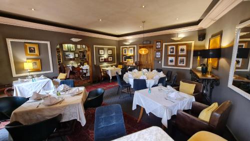 a restaurant with two tables and chairs and tablesearcher at Le Loft in Bamako