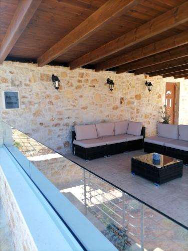 an outdoor patio with a couch and a table at VILLA HALEPOURI in Chania Town