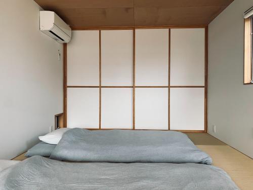 a bedroom with a bed with a large headboard at FUN - Vacation STAY 48765v in Kanazawa