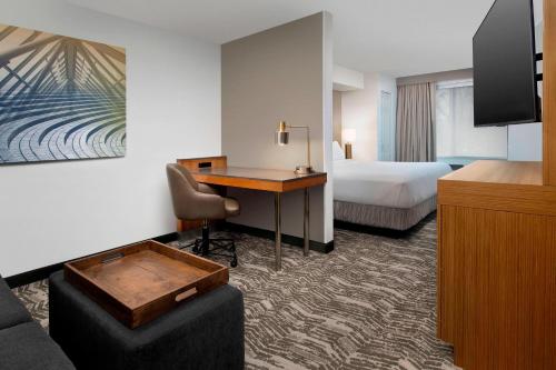 a hotel room with a desk and a bed at SpringHill Suites by Marriott Portland Hillsboro in Hillsboro