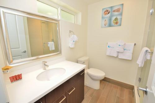 a white bathroom with a sink and a toilet at Royal St. Kitts Hotel in Frigate Bay