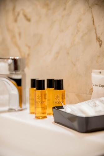 a shelf with three bottles of essential oils on it at RESIDENCE VILLA TOTA in Spoleto