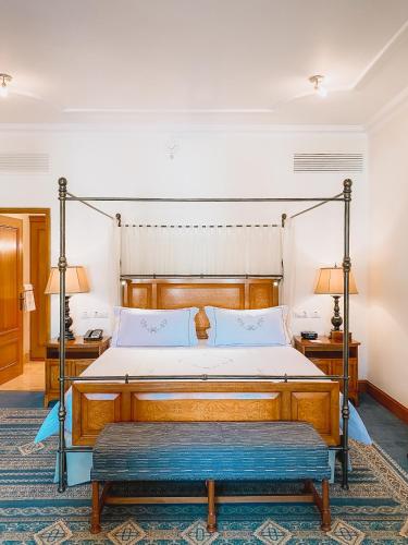 a bedroom with a bed with a metal frame at Palacio Nazarenas, A Belmond Hotel, Cusco in Cusco