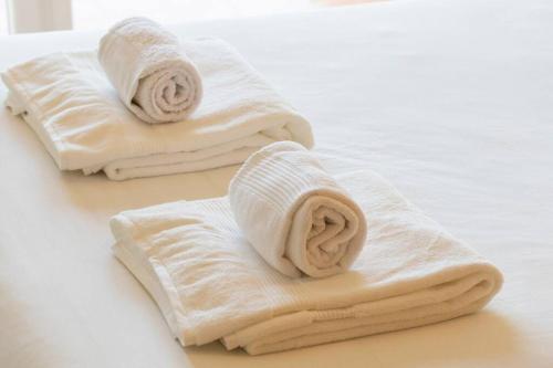 two towels sitting on top of a table at Casa da Praça in the center of Porto - GuestSPA in Porto