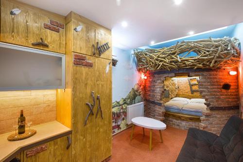 a room with a bed and a brick wall at Hotel Kocourkov in Hlinsko