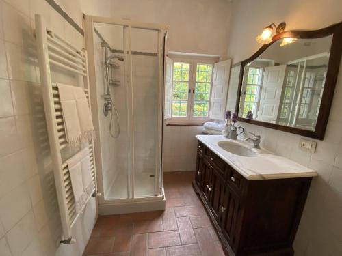 a bathroom with a shower and a sink and a mirror at Casa spaziosa in caratteristico paesino di alta collina in Santa Maria Albiano