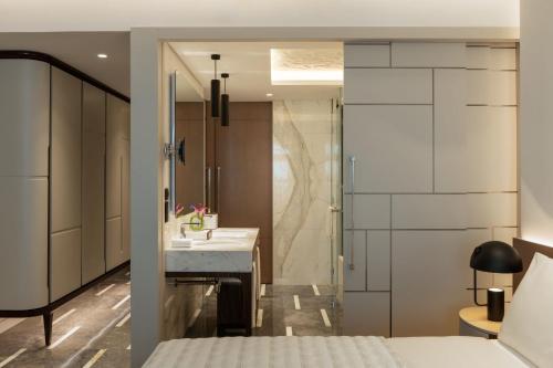 a bathroom with a sink and a shower at Le Royal Méridien Place Vendôme Lusail in Doha