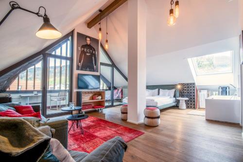 a large living room with a couch and a bed at Hirschen Erlinsbach Swiss Quality in Erlinsbach
