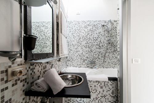 a bathroom with a sink and a bath tub at La Mansardina di Giuly by Quokka 360 - bright attic apartment in the centre of Como in Como